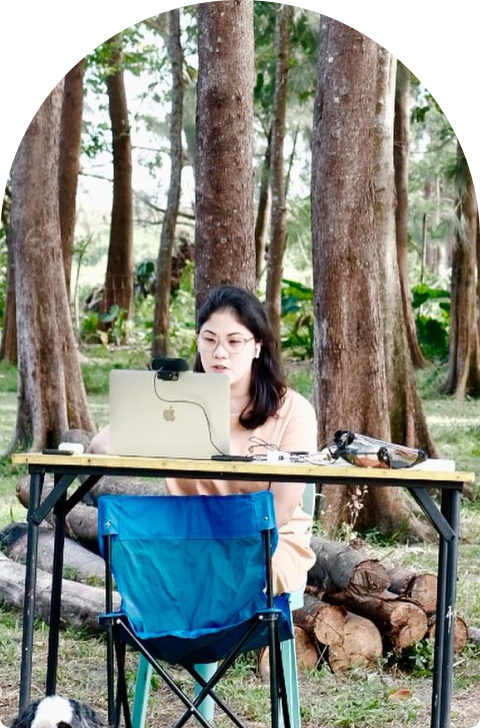 Gina Roldan, founder of Our Living Learning, reading Charlotte Mxason’s works in nature with her children, inspired by gentle education principles.